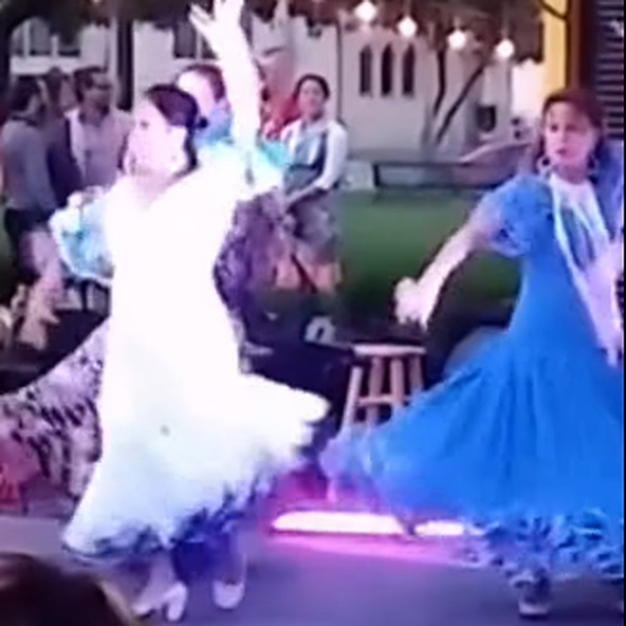 España Viva dancers performing in white and blue dresses